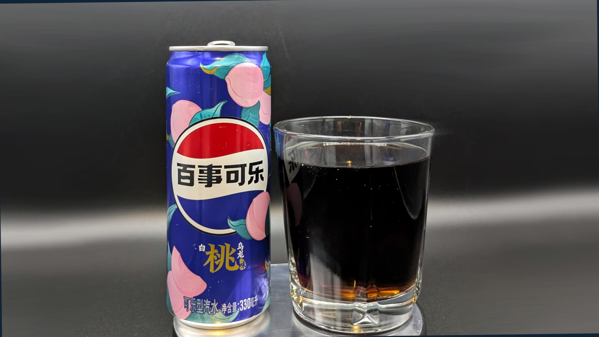 A can of Pepsi White Peach Oolong Soda next to a glass filled with Pepsi White Peach Oolong Soda.